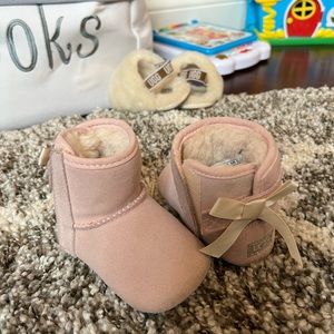 Baby Uggs, pink with bow on back. Velcro on sides for easy on off. Size 2/3.